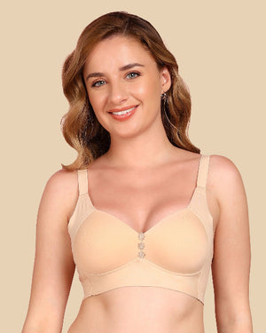 Woman wearing a beige bra against a beige background