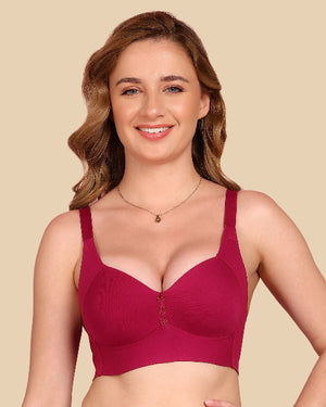 Woman wearing a maroon bra against a beige background