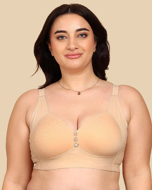 Woman wearing a beige bra against a beige background