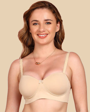 Woman wearing a beige bra against a beige background