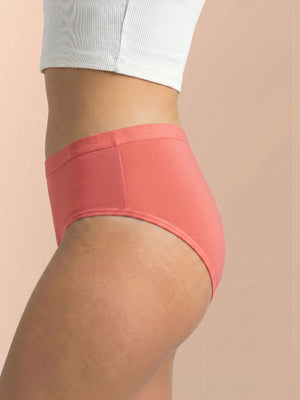 Person wearing coral high-waisted underwear on a beige background