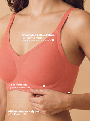 Peach-colored bra with text highlighting features on a beige background