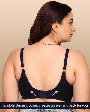 Woman wearing a black bra with visible underwire on a beige background