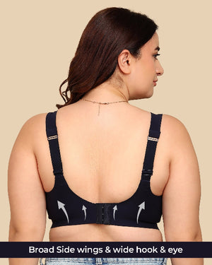 Woman wearing a black bra with wide hook and eye closure on a beige background