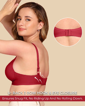 Woman wearing a red bra with a close-up of the U-back closure mechanism on a beige background.
