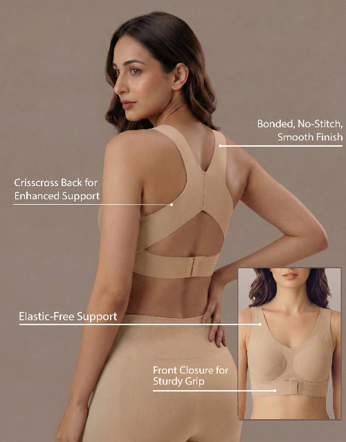 Woman wearing a beige support garment with feature labels on a beige background