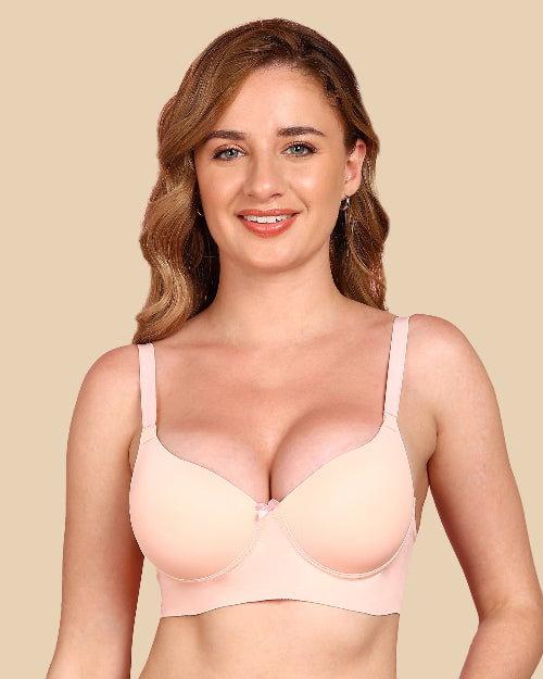 Woman wearing a beige bra against a beige background