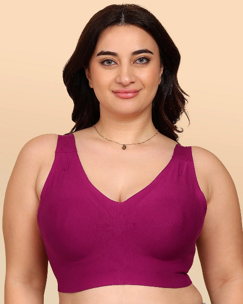 Woman wearing a purple bralette against a beige background