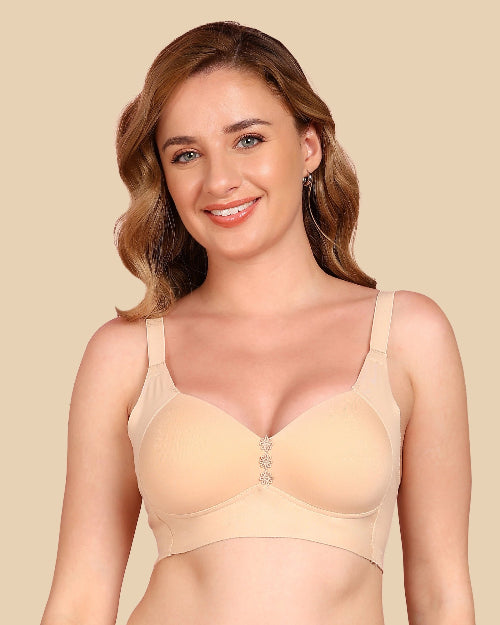 Woman wearing a beige bra against a beige background