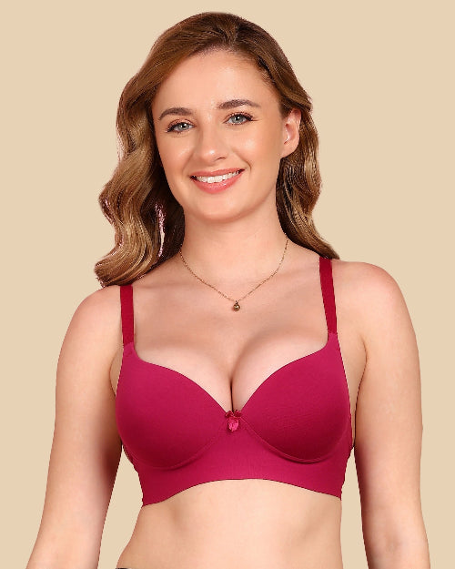 Woman wearing a pink bra against a beige background