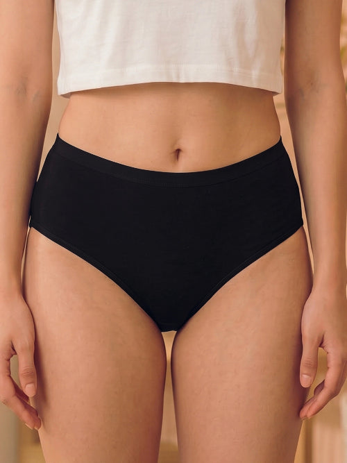 Person wearing black high-waisted underwear with a neutral background