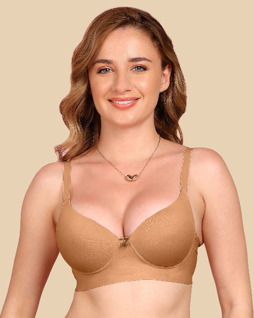 Woman wearing a beige bra against a beige background
