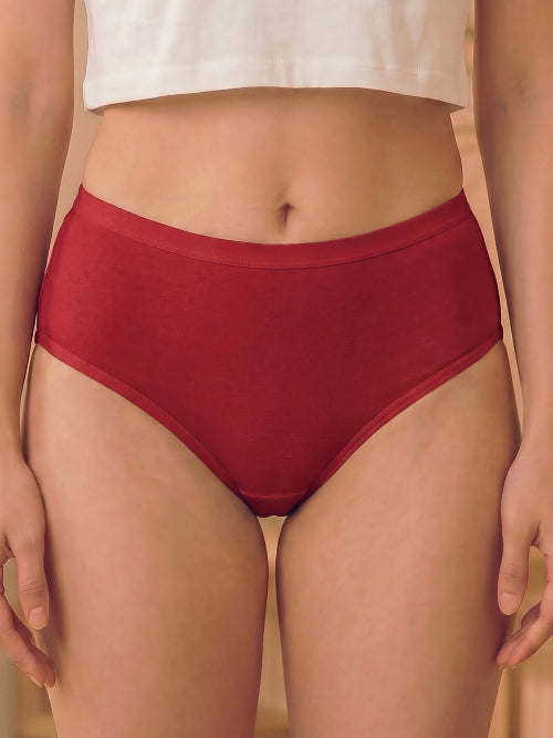 Red high-waisted underwear worn by a person on a neutral background