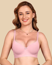 Woman wearing a pink bra against a beige background
