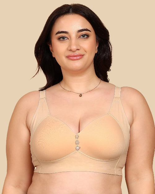 Woman wearing a beige bra against a beige background