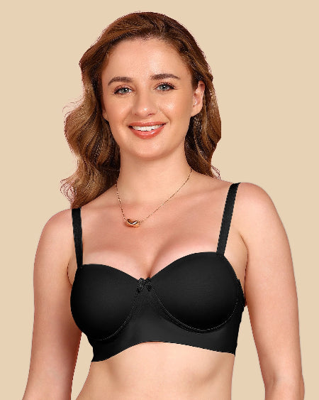 Woman wearing a black bra against a beige background