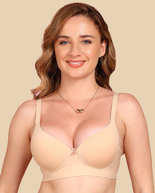 Woman wearing a beige bra against a beige background