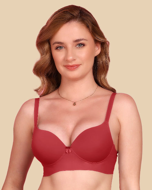 Woman wearing a red bra against a beige background