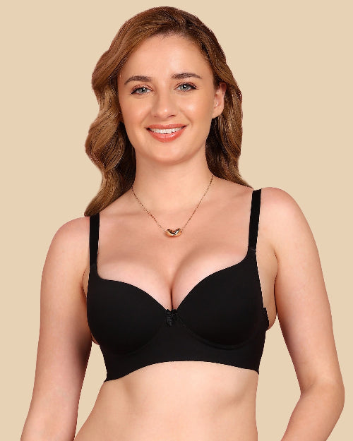 Woman wearing a black bra against a beige background