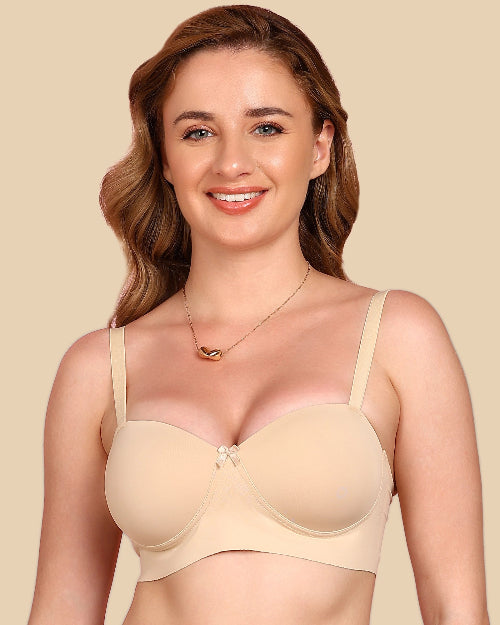 Woman wearing a beige bra against a beige background