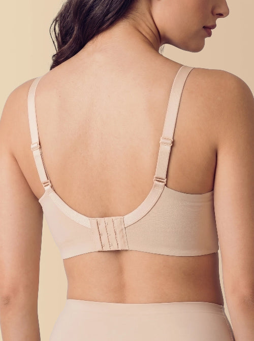 Beige bra worn by a person on a beige background