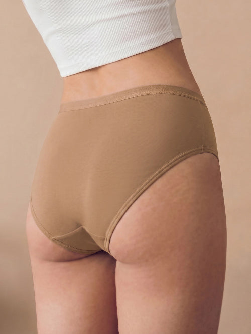 Beige underwear worn by a person on a beige background