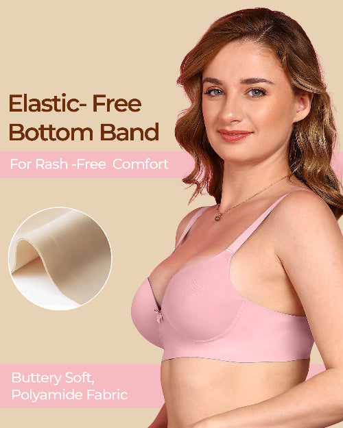Woman wearing a pink bra with text about elastic-free bottom band and buttery soft fabric.