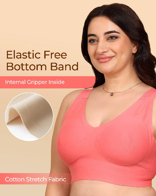 Woman wearing a pink bra with text about an elastic free bottom band and cotton stretch fabric.