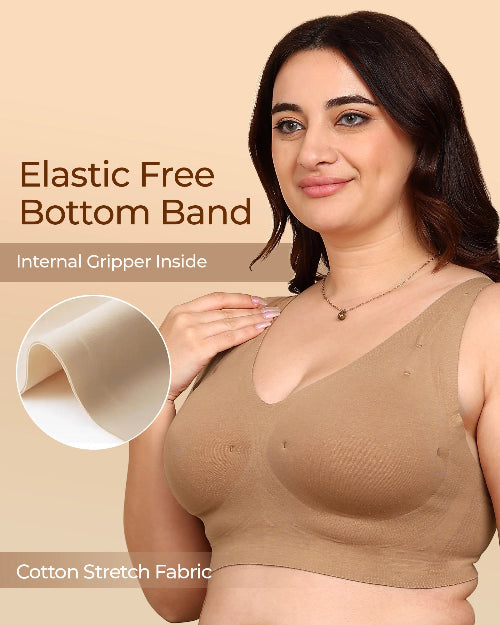 Woman wearing a beige bra with text about an elastic free bottom band and cotton stretch fabric.