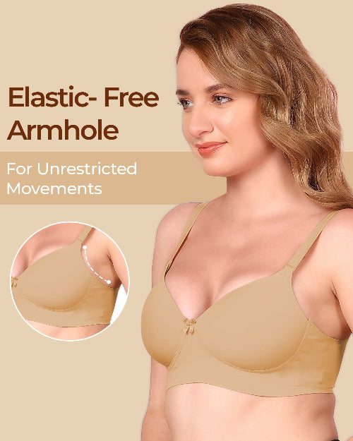 Woman wearing a beige bra with an elastic-free armhole feature, on a beige background.