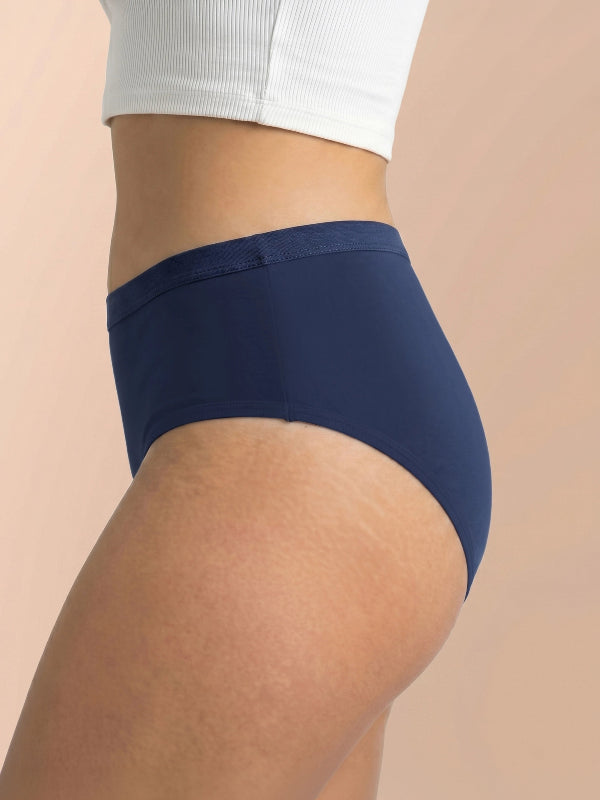 Navy blue underwear worn by a person on a beige background