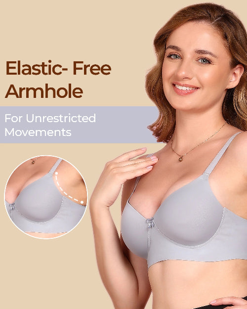 Woman wearing a gray bra with an elastic-free armhole feature on a beige background.