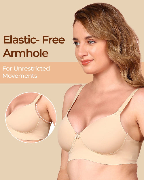 Woman wearing a beige bra with 'Elastic-Free Armhole' feature on a beige background