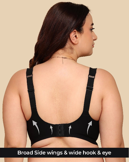 Woman wearing a black sports bra with visible features on a beige background