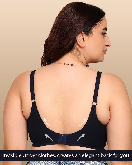 Woman wearing a black bra with visible underwire on a beige background