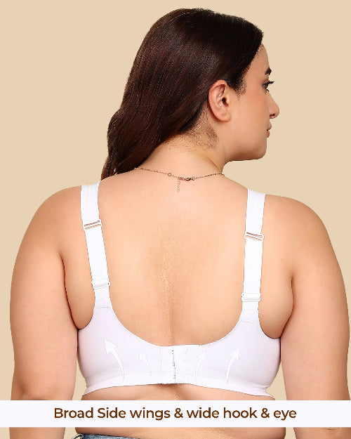 Woman wearing a white bra with broad side wings and wide hook & eye on a beige background