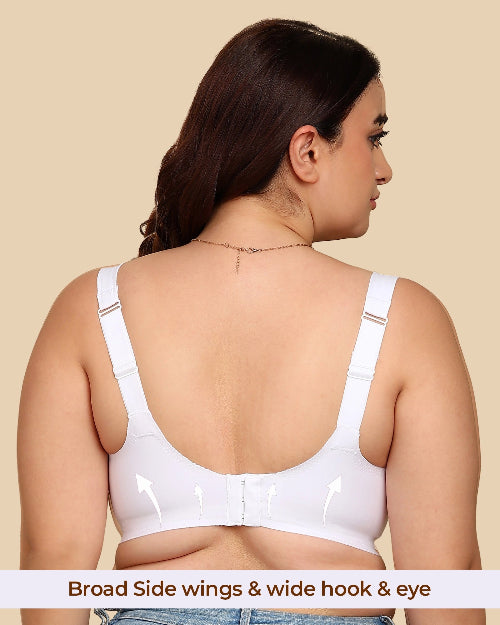 Woman wearing a white bra with wide hook and eye closure on a beige background