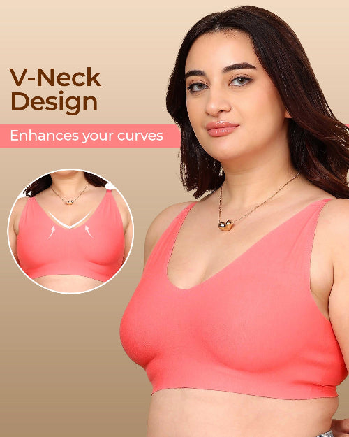 Woman wearing a pink V-neck top with text highlighting the design on a beige background