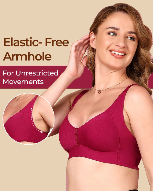 Woman wearing a red bra with an elastic-free armhole feature, on a beige background.
