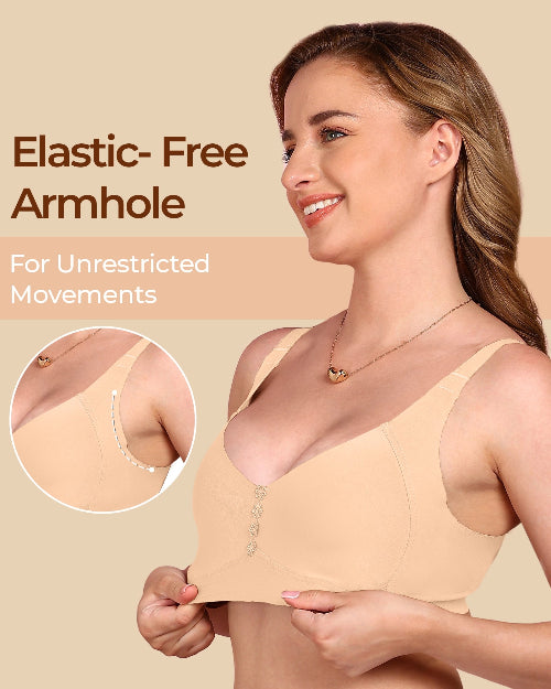 Woman wearing a beige bra with an elastic-free armhole feature, on a beige background.