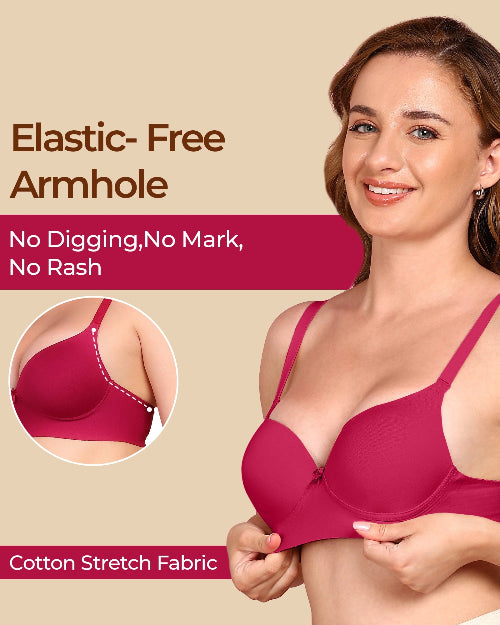 Woman wearing a pink bra with text highlighting elastic-free armhole design on a beige background