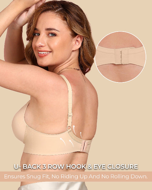 Woman wearing a beige bra with close-up of closure mechanism on a beige background