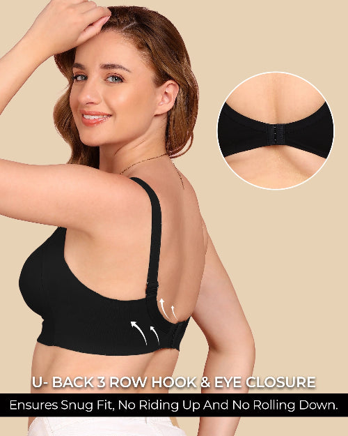 Woman wearing a black bra with a close-up of the U-back closure on a beige background.