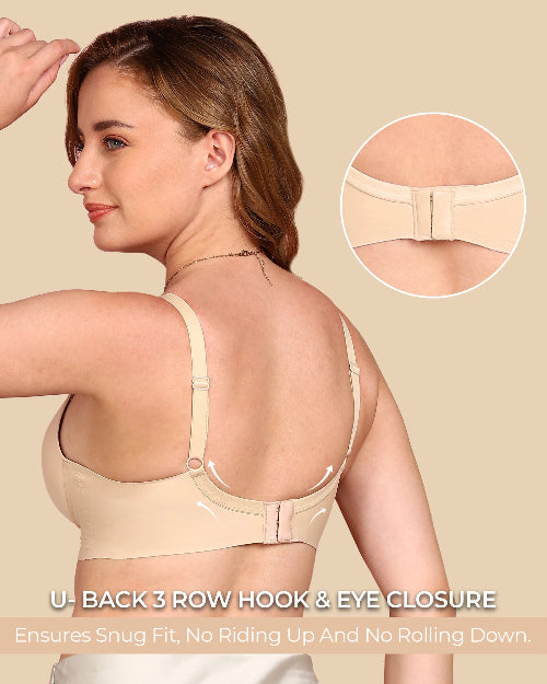 Woman wearing a beige bra with close-up of back closure on a beige background