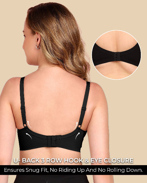 Woman wearing a black bra with U-back 3 row hook & eye closure on a beige background.