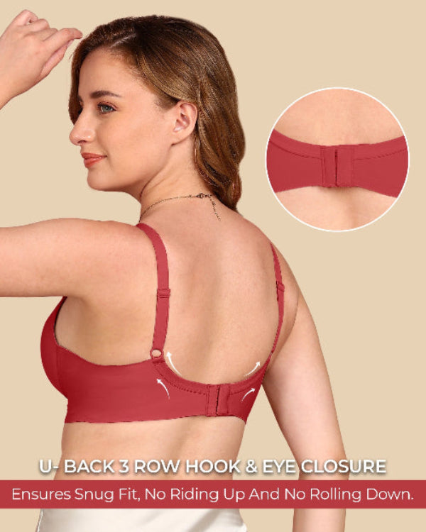 Woman wearing a red sports bra with a close-up of the back design on a beige background.