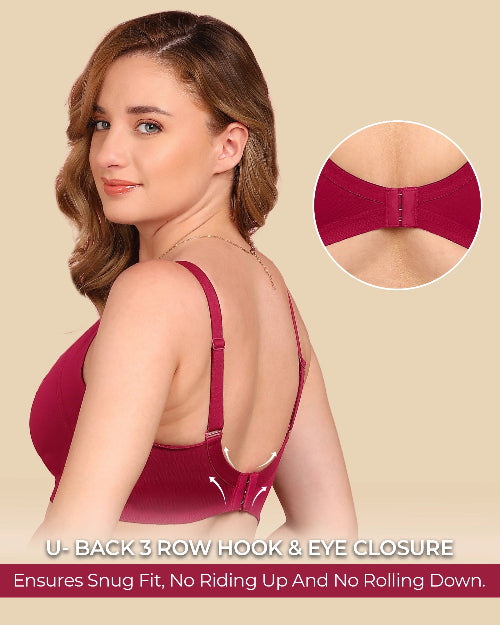 Woman wearing a red bra with close-up of hook and eye closure on beige background