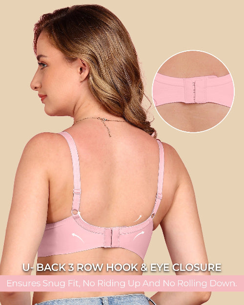 Woman wearing a pink bra with close-up of back closure on beige background