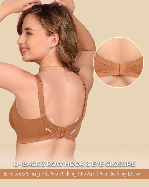Woman wearing a brown bra with close-up of U-back closure on beige background
